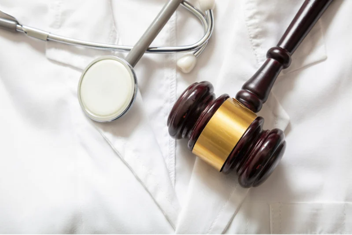 White doctor coat with stethoscope and gavel