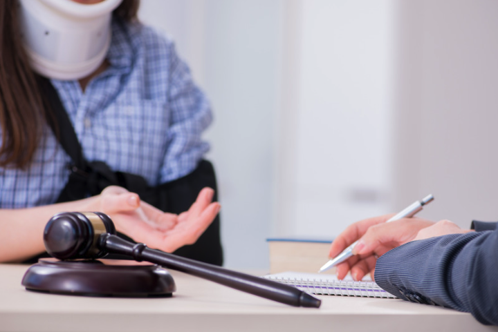 Injured woman discussing with her slip and fall attorney